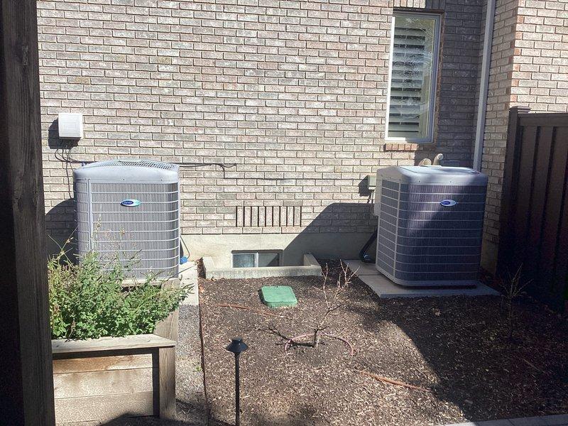 Performed comprehensive tech lead evaluation on dual-zone HVAC system consisting of two furnaces (one basement-mounted, one upstairs closet installation) and two ground-level air conditioning condensers. Assessed aging equipment condition following previous heating maintenance and determined both systems require significant repairs or replacement due to age and deteriorating performance. Presented replacement options including full system upgrades with air scrubber and humidifier integration for improved indoor air quality and humidity control across both zones.