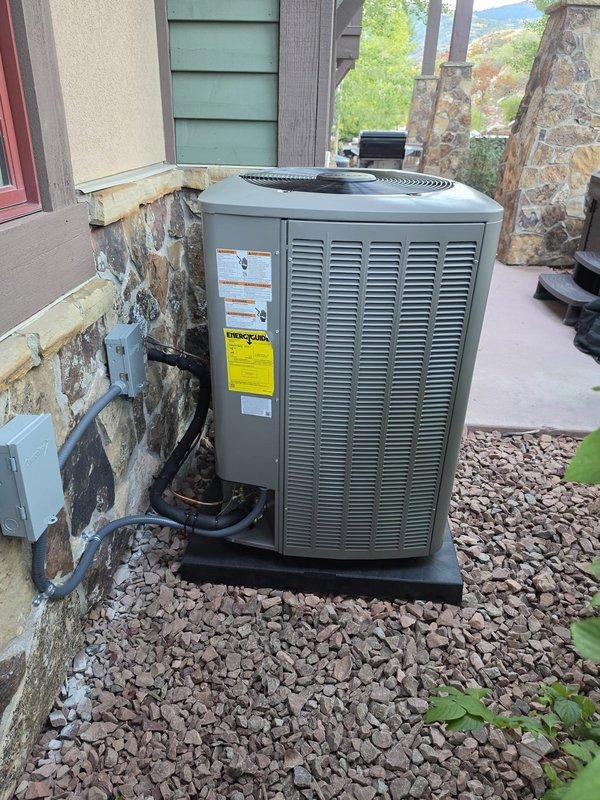 Completed full HVAC system replacement in basement, installing EL297UH070XV36BK 90% efficiency furnace on return air base and EL18KCV-036 3-ton air conditioning condenser unit. Installed CK40CT-36B-71 evaporator coil, iComfort S40 thermostat utilizing existing 5-wire configuration, and Aprilaire 800 steam humidifier with 36x36x3 pad. Added 20x25x5 media cabinet with MERV 11 filter for improved air filtration. Reused existing refrigerant lineset after performing system flush to ensure clean operation. Mounted outdoor condenser on pad with proper clearance and connected refrigerant lines and electrical conduit to exterior wall. Prepared and cleaned installation area prior to furnace placement. System startup and testing completed successfully. Note: Dedicated breaker for steam humidifier will require separate electrical service call for installation.