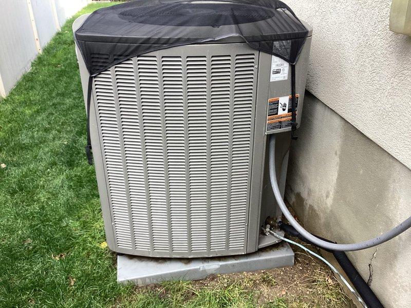 Completed annual air conditioning maintenance tune-up as part of membership preventive maintenance program. Performed comprehensive inspection of outdoor condenser unit located on side of residence, verified proper operation of all components, and documented equipment condition with photographic records. System found operating within normal parameters with protective covering in place and electrical disconnect box properly installed and functioning.