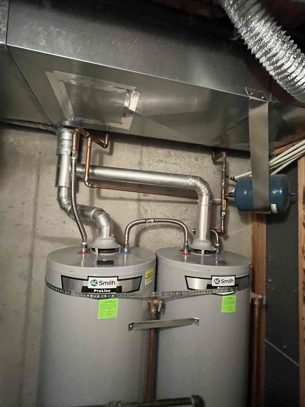 Assessed two 9-year-old AO Smith ProLine 40-gallon water heaters that had previously been exposed to excessive water pressure (approximately 120 PSI) prior to PRV installation. Provided estimate for removal of both existing units and replacement with a single 50-gallon water heater, including code compliance upgrades: replacement of broken 2-gallon expansion tank, upgrading undersized 3-inch exhaust venting to proper diameter, installation of required drip leg on gas line, updated earthquake strapping, and replacement of 2-3 inches of PEX piping near PRV with copper line.