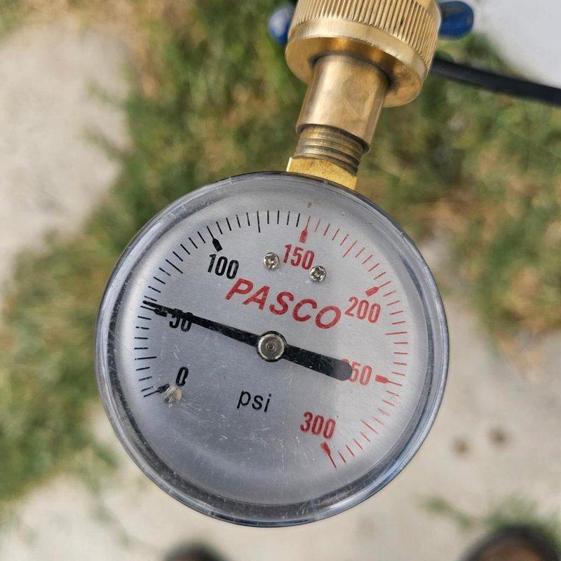 Responded to service call for a 6-year-old water heater experiencing chronic leaking for approximately one year and intermittent pilot light failure resulting in frequent shutdowns and potential loss of hot water. Performed diagnostic assessment of the unit to identify the source of the leak and determine the cause of repeated flame-out conditions. Measured system water pressure at approximately 50 PSI using calibration gauge to verify proper operating parameters. Communicated diagnostic findings and repair options to customer via text message, including explanation of service scope, warranty terms for workmanship, and clarification that no warranty coverage applies to components installed by other contractors.