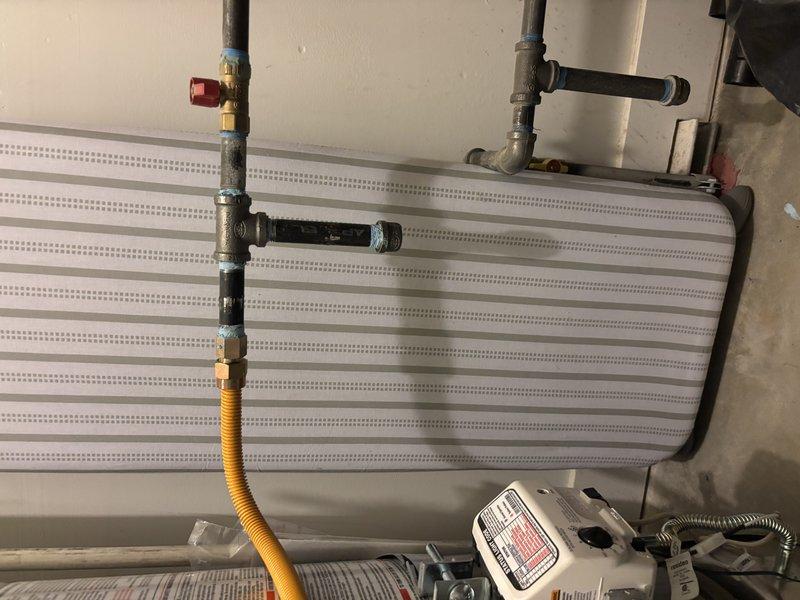 Responded to no hot water complaint on 5-year-old tanked water heater located in garage. Upon arrival, discovered gas supply had been shut off to unit. Performed diagnostic inspection of water heater system, checked gas line connections, pressure readings, and safety controls. Verified all plumbing connections and fittings were secure, inspected temperature and pressure relief valve, and assessed overall system functionality to restore hot water service to the home.