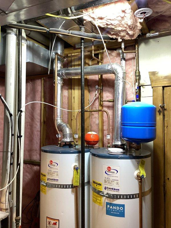 Conducted on-site evaluation for complete HVAC system replacement serving approximately 3,500 square feet covering main floor and basement areas. Assessed existing 20-year-old Carrier furnace with failed indoor blower motor that customer elected not to repair. Evaluated property for Tier 2 Dual-Fuel Hybrid Heat Pump system installation to meet Rocky Mountain Power Wattsmart and Enbridge Gas ThermWise rebate program requirements. Documented existing dual outdoor Lennox condenser units positioned on exterior wall with refrigerant line connections. Reviewed mechanical room containing dual gas-fired water heaters with proper venting and expansion tank configuration. Prepared recommendations for factory-matched equipment with AHRI Certified Reference Numbers to ensure rebate eligibility verification. Discussed Manual J Load Calculation requirements for proper variable-speed equipment sizing based on home layout and square footage.