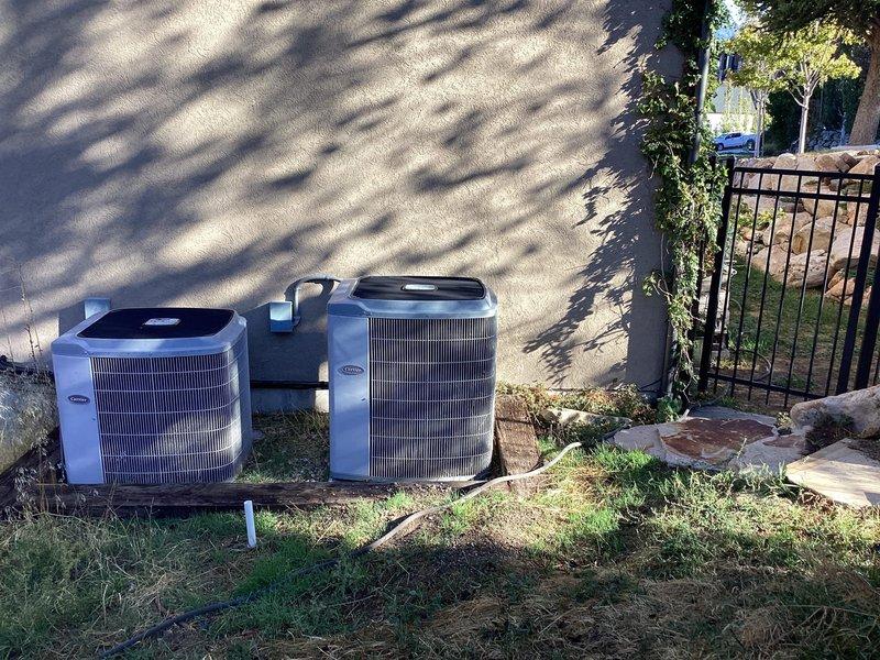 Conducted on-site evaluation for complete HVAC system replacement serving approximately 3,500 square feet covering main floor and basement areas. Assessed existing 20-year-old Carrier furnace with failed indoor blower motor that customer elected not to repair. Evaluated property for Tier 2 Dual-Fuel Hybrid Heat Pump system installation to meet Rocky Mountain Power Wattsmart and Enbridge Gas ThermWise rebate program requirements. Documented existing dual outdoor Lennox condenser units positioned on exterior wall with refrigerant line connections. Reviewed mechanical room containing dual gas-fired water heaters with proper venting and expansion tank configuration. Prepared recommendations for factory-matched equipment with AHRI Certified Reference Numbers to ensure rebate eligibility verification. Discussed Manual J Load Calculation requirements for proper variable-speed equipment sizing based on home layout and square footage.