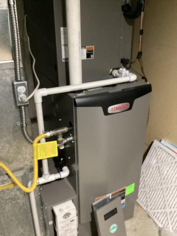 Completed comprehensive membership maintenance on residential HVAC system including both heating and cooling equipment. Performed full inspection and tune-up of Lennox furnace located in basement, verifying proper operation of all components, gas connections, and safety controls. Measured electrical amperage draw using clamp meter to confirm system operating within manufacturer specifications at 5 amps AC. Inspected condensate drain lines, PVC venting system, and flexible gas line connections for proper installation and function. Evaluated air filter condition and system airflow. Proceeded to outdoor AC unit located on south side of property in backyard and performed seasonal cooling system maintenance including coil inspection, refrigerant level verification, and operational testing. All equipment found operating properly with no deficiencies noted. System ready for continued service.