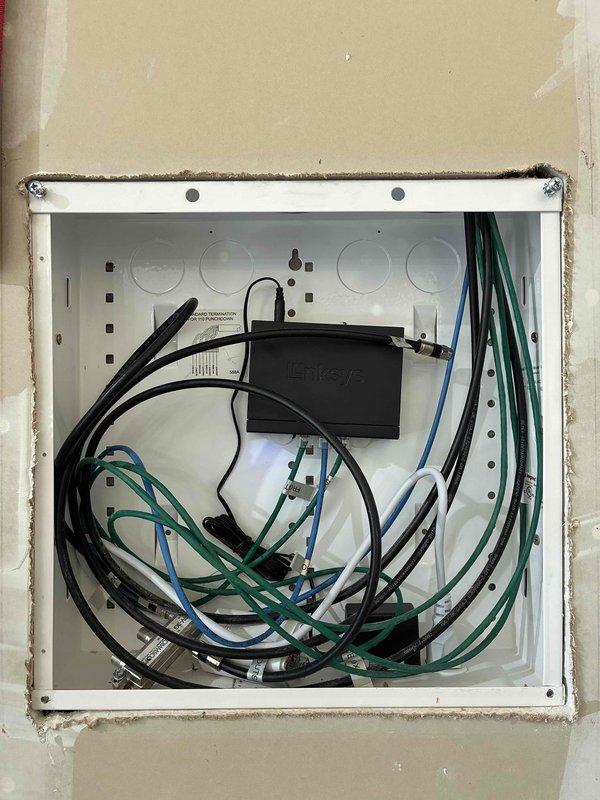 Completed comprehensive electrical safety maintenance inspection as part of membership preventive maintenance program. Performed thorough evaluation of main electrical panel, inspected all visible connections for proper torque and signs of overheating or arcing, and verified panel labeling accuracy. Tested all accessible GFCI outlets and standard receptacles throughout the residence for proper operation and grounding. Inspected light switches and fixtures for functionality and secure mounting. Verified operation of smoke detectors and carbon monoxide detectors, confirming proper placement and battery status. Examined visible wiring for signs of damage, improper installation, or potential fire hazards. Documented HVAC system electrical components including capacitor condition and wiring connections. Noted wall-mounted networking enclosure with router installation and associated low-voltage cabling. All electrical systems found operating within normal parameters with no immediate safety 