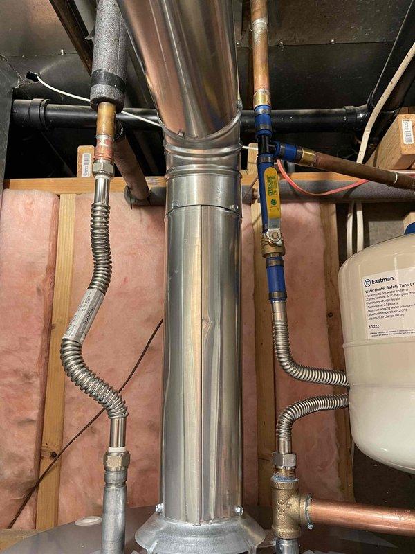 Removed existing water heater after shutting off water supply and draining system. Installed new 50-gallon Rheem water heater with thermal expansion tank, temperature and pressure relief valve drop tube, sediment collector, seismic straps, properly sized venting, and drain pan piped to waste line. Replaced 20-inch carbon block filter and big blue housing as part of the water treatment system maintenance. All connections secured with appropriate fittings and materials, including copper and PEX piping as needed. Obtained permit and completed installation to code. Tested all connections for leaks, verified proper water flow, confirmed temperature and pressure relief valve operation, and ensured system functionality before completing the job.