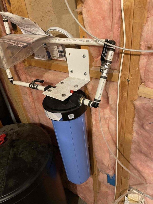 Removed existing water heater after shutting off water supply and draining system. Installed new 50-gallon Rheem water heater with thermal expansion tank, temperature and pressure relief valve drop tube, sediment collector, seismic straps, properly sized venting, and drain pan piped to waste line. Replaced 20-inch carbon block filter and big blue housing as part of the water treatment system maintenance. All connections secured with appropriate fittings and materials, including copper and PEX piping as needed. Obtained permit and completed installation to code. Tested all connections for leaks, verified proper water flow, confirmed temperature and pressure relief valve operation, and ensured system functionality before completing the job.