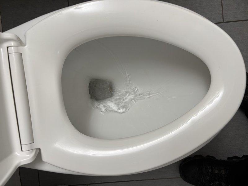 Responded to callback for recurring toilet stoppage previously augured during initial service call. Removed toilet from flange to access and clear obstruction that could not be resolved through auguring alone. Identified foreign object lodged in trapway causing repeated blockage. Extracted debris, cleared drain line, and inspected toilet bowl and internal passages for damage. Replaced wax ring seal at flange connection and reinstalled toilet to proper specifications. Tested flush operation and verified full drainage with no backup or slow flow issues.