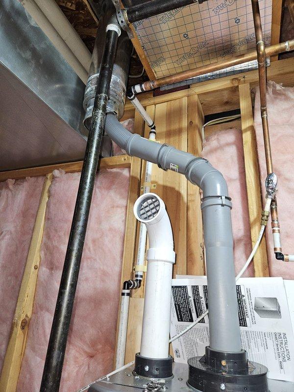 Successfully removed two existing 50-gallon tank water heaters and replaced with a new Rinnai tankless water heater system with descaler unit. Installation included routing new PVC venting through wall framing, installing gas line with flexible connector and shut-off valve, configuring water supply lines with copper and PEX piping, and ensuring proper condensate drainage. All connections tested and verified for safe operation, with unit commissioned and ready for service.