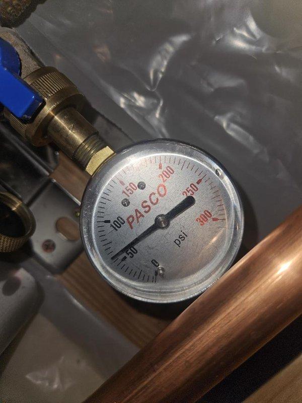Replaced malfunctioning flow sensor on residential plumbing system located in basement. Verified system pressure readings using gauge assembly and confirmed proper operation of replacement sensor. Collected water sample for testing and documented pre- and post-repair pressure measurements to ensure optimal system performance.