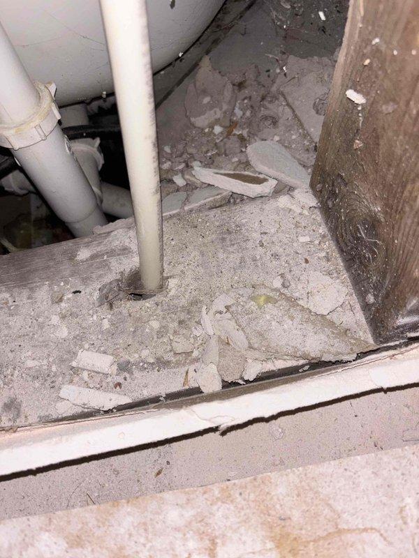 Responded to reported leak originating from upstairs shower and penetrating through to the basement below. Upon inspection, identified water intrusion through the floor assembly affecting the recently refinished basement ceiling. Documented existing water damage to building materials and debris accumulation on basement floor, along with examination of plumbing supply lines and drainage components in the affected area.