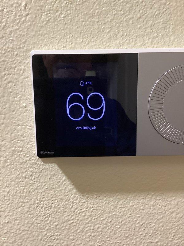 Completed comprehensive annual maintenance inspection on residential HVAC system including blower motor assembly, electrical connections, and Daikin thermostat verification. Inspected internal furnace components, verified proper motor operation and mounting hardware integrity, checked all wire connections and safety controls, and confirmed thermostat functionality displaying 69°F with humidity monitoring at 47% in air circulation mode.