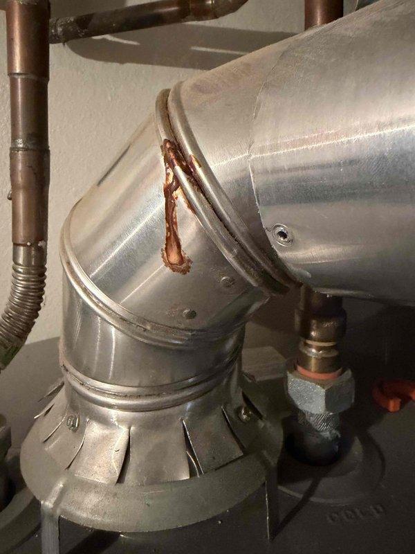 Responded to service call for discolored water issue and performed non-member plumbing inspection. Upon arrival, assessed water heater system and surrounding plumbing connections to diagnose cause of yellow-tinted water. Inspected copper piping, HVAC ductwork connections, and mechanical components in utility space, noting rust deposits and oxidation on duct seams that could indicate moisture infiltration in the area. Documented existing conditions of plumbing infrastructure including copper lines, PVC drainage, and water heater connections to provide comprehensive assessment for recommended water heater flush service.
