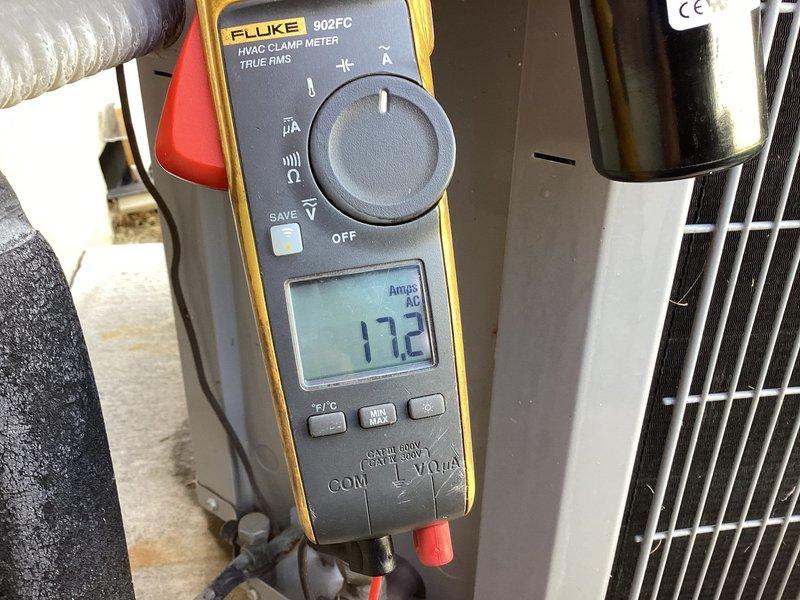 Responded to service call for 10-year-old Carrier air conditioning unit blowing warm air. Performed diagnostic evaluation of outdoor condensing unit using Fluke 902FC HVAC clamp meter to measure electrical current draw, recording amperage readings of 11.5A and 17.2A on system components. Conducted electrical testing and system performance analysis to identify root cause of cooling failure.