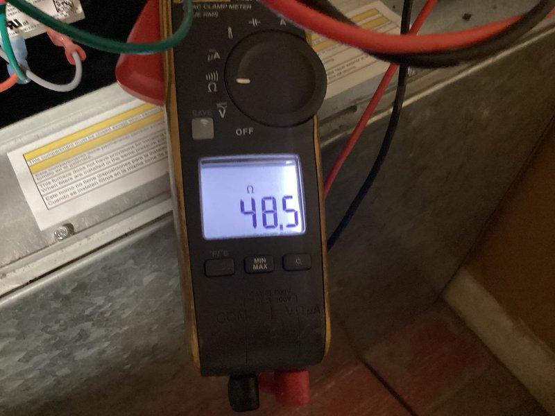 Performed routine maintenance on residential furnace system in basement utility area. Tested and verified flame sensor operation with multimeter, recording reading of 48.5 microamps to confirm proper flame detection functionality. Replaced air filter and inspected gas lines, ductwork connections, and overall system operation to ensure safe and efficient performance.