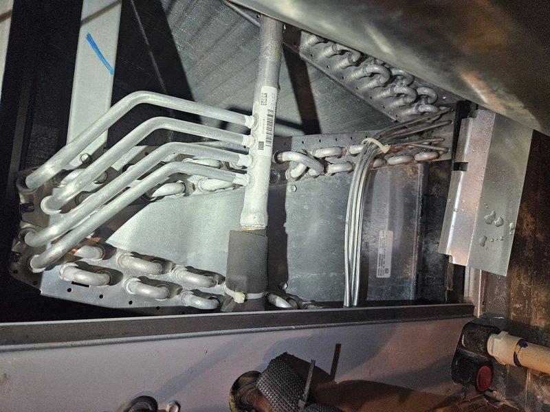 Responded to emergency call for water leak from furnace creating significant flooding in basement utility area. Upon inspection, determined leak was originating from condensate drainage system on 5-6 year old furnace unit. Found condensate drain line clogged, causing backup and overflow that resulted in extensive standing water accumulation around furnace and water heater. Cleared blockage from condensate drain line and PVC piping, verified proper drainage flow restored, and tested system operation to ensure no further leakage. Advised on water extraction needs for flooded area and recommended monitoring condensate system regularly to prevent future occurrences.
