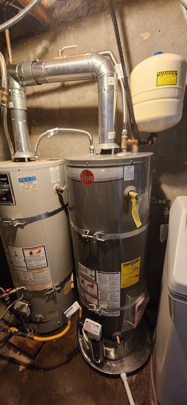 Installed 50-gallon residential water heater in basement mechanical room with full code compliance including proper venting system, gas line connections, expansion tank, earthquake restraint straps, new copper supply lines, and shutoff valve. Removed and disposed of existing water heater, completed all connections per manufacturer specifications, performed system light-off and operational testing to verify proper function and safety of new unit with 6-year manufacturer warranty coverage.