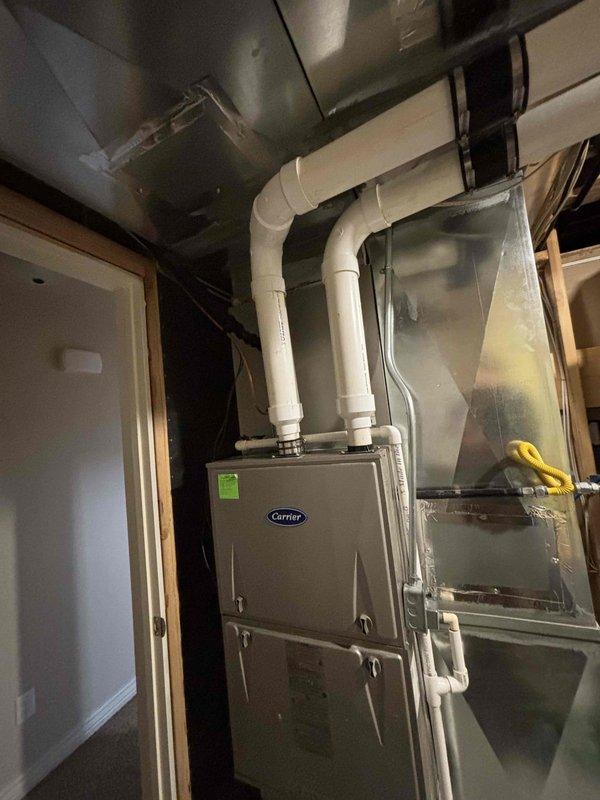 Responded to service call for 10-year-old Carrier AC unit blowing warm air. Performed diagnostic evaluation of residential HVAC system including visual inspection of outdoor condensing unit and indoor furnace components. Diagnosed compressor failure on 2015 Carrier air conditioning unit. Documented internal furnace components including blower assembly, gas valve, control mechanisms, and ductwork configuration. Provided estimate for compressor repair and presented replacement system options ranging from standard to premium efficiency equipment.