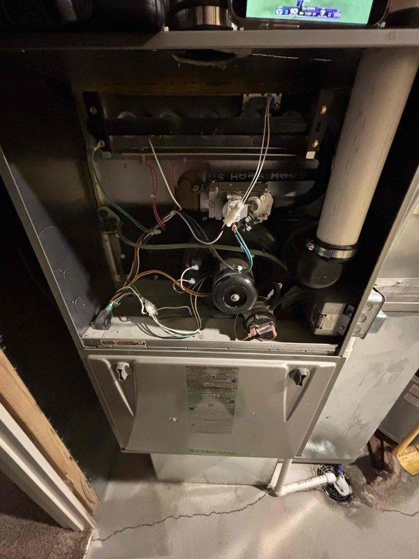Responded to service call for 10-year-old Carrier AC unit blowing warm air. Performed diagnostic evaluation of residential HVAC system including visual inspection of outdoor condensing unit and indoor furnace components. Diagnosed compressor failure on 2015 Carrier air conditioning unit. Documented internal furnace components including blower assembly, gas valve, control mechanisms, and ductwork configuration. Provided estimate for compressor repair and presented replacement system options ranging from standard to premium efficiency equipment.