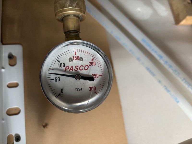 Replaced water pressure regulator valve and verified system pressure reading at 150 PSI using calibrated PASCO gauge. Installed customer-provided under-sink water filtration unit in kitchen cabinet with complete plumbing integration, including PVC pipe connections, supply line hookups, and drain line configuration. Tested all connections for leaks and confirmed proper operation of filtration system controls.