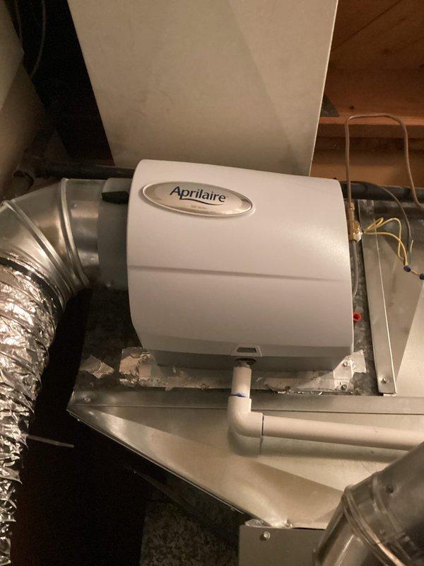 Completed annual heating maintenance on 4-year-old furnace system located in basement. Performed comprehensive inspection of heating equipment including furnace, Aprilaire humidifier unit mounted on plenum, and associated components. Inspected humidifier operation, PVC drainage lines, electrical connections, and ductwork. Verified proper function of accumulator, examined internal components, and confirmed all warning labels and safety markings were visible and intact. No issues reported by customer and no deficiencies found during inspection. All equipment operating within normal parameters.