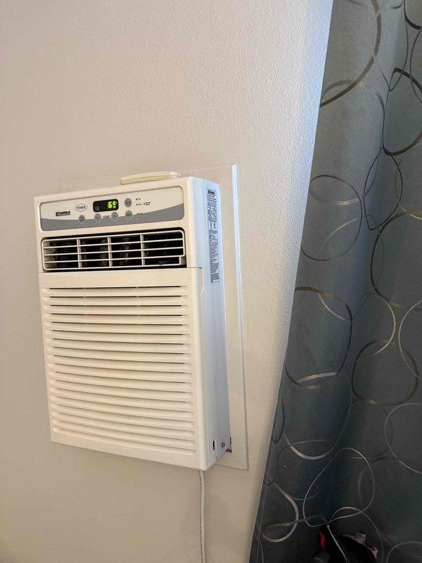 Evaluated existing non-functioning air conditioning system and provided estimate for mini-split installation to serve single room. Assessed current outdoor condenser unit mounted on exterior wall with refrigerant line set, and inspected indoor portable AC unit currently in use within the space. Discussed mini-split system options as replacement solution for failed existing equipment, reviewed installation requirements including outdoor condenser placement and indoor air handler positioning, and presented equipment specifications and financing options to facilitate timely system replacement.