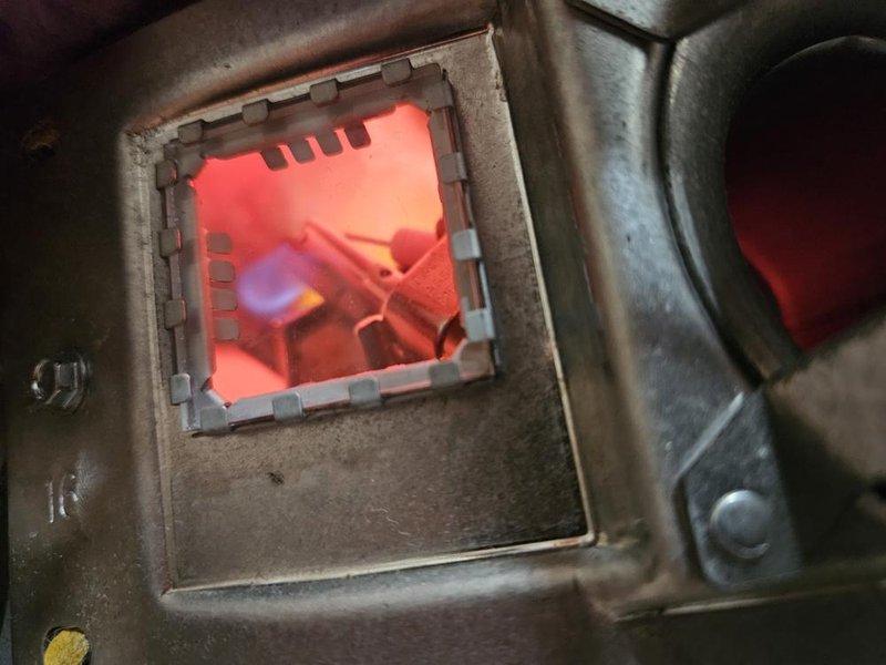 Responded to no hot water complaint on 6-year-old tank-style water heater located in basement. Upon inspection, found unit with operational burner assembly showing proper combustion with blue flame pattern visible through viewing port. Verified gas supply, ignition system, and burner operation were functioning correctly, restoring hot water service to the home.