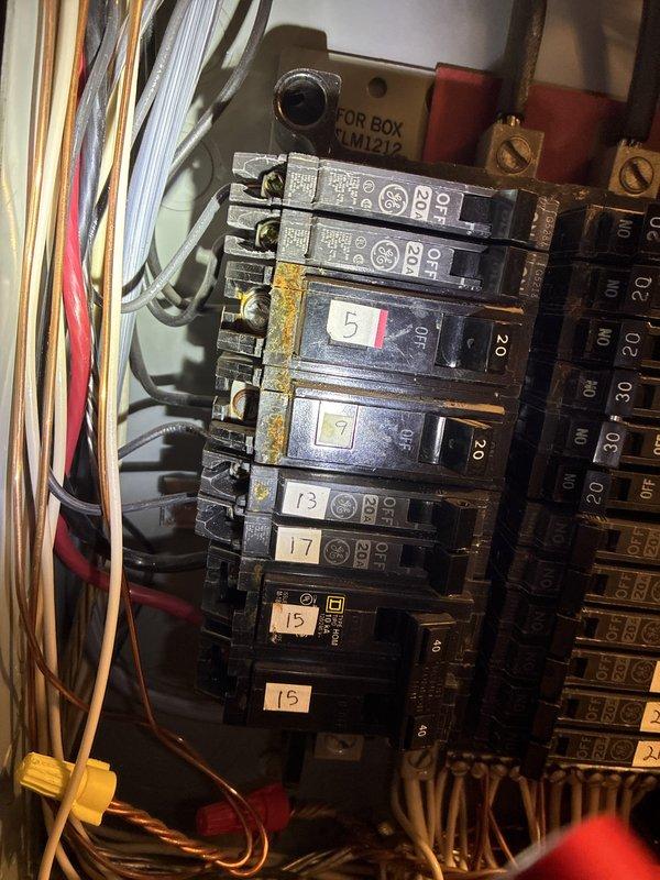 Completed annual preventative electrical maintenance inspection as part of recurring membership service. Performed comprehensive evaluation of main electrical panel, circuit breakers, and all visible wiring connections. Inspection revealed oxidation and yellowish-brown discoloration on multiple breaker terminals, particularly on breaker #5, indicating age-related corrosion at connection points. Examined terminal block assembly with multiple wire connections and verified proper wire bundling and organization. Documented panel condition showing standard residential circuit breaker configuration with numbered breakers and color-coded wiring throughout. All circuit breakers operational with no tripping issues reported. Noted general age-related wear on components but no immediate safety concerns requiring emergency repair. Photographed panel interior and terminal connections for maintenance records.