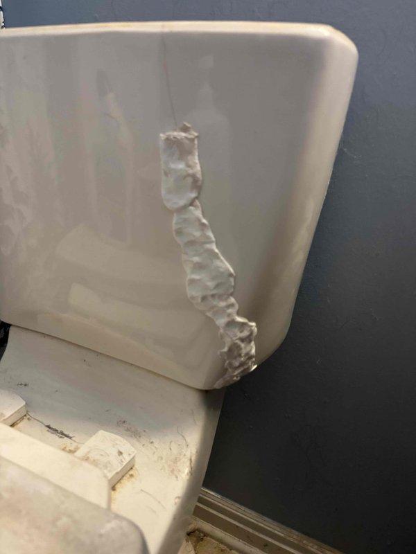 Responded to service call for cracked American Standard 4266 toilet tank requiring replacement. Upon inspection, confirmed vertical crack in tank wall with evidence of water damage and deteriorated sealant, along with significant mineral buildup and aging internal flush components. Due to discontinued tank model availability, recommended and completed full toilet replacement rather than tank-only repair to ensure proper function and prevent future leaks.