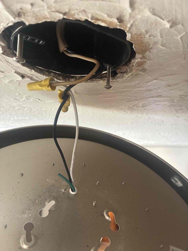 Responded to service call for assistance with ceiling-mounted LED light fixture in main level living room that customer had removed for cleaning and was unable to reinstall. Upon arrival, assessed the fixture components including the LED array circuit board, driver/transformer with associated wiring, and ceiling mounting hardware. Successfully reconnected electrical wiring, secured the driver unit to the junction box, properly seated the LED array and trim ring assembly, and restored the fixture to full operation with secure ceiling mounting.