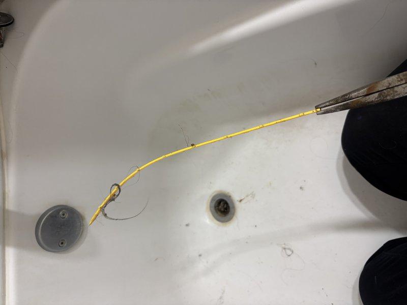 Responded to slow-draining bathtub in second-floor bathroom where homeowner's snake had broken off inside the drain line. Successfully extracted the broken snake cable from the drain and cleared the obstruction, restoring proper drainage to the fixture.