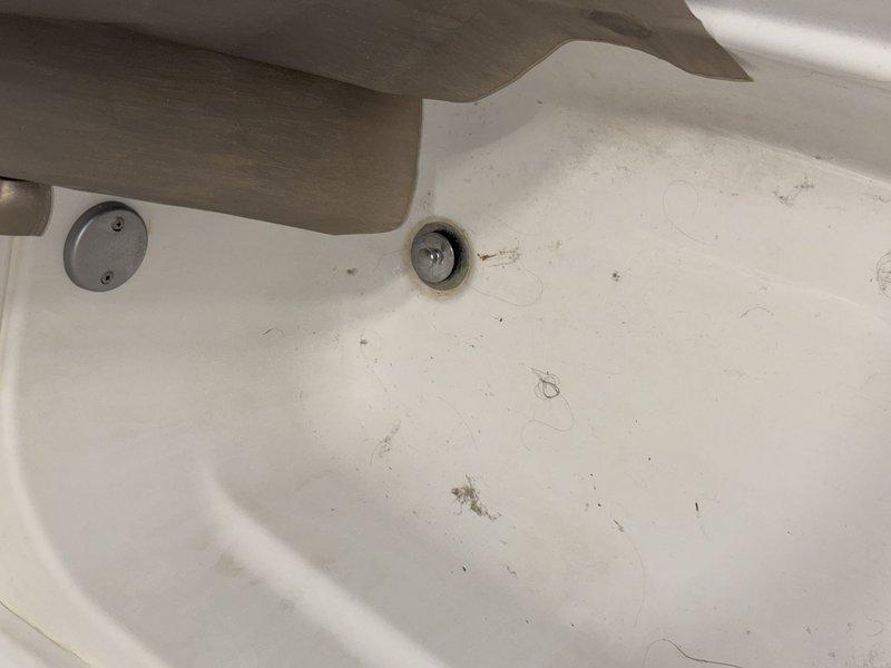 Responded to slow-draining bathtub in second-floor bathroom where homeowner's snake had broken off inside the drain line. Successfully extracted the broken snake cable from the drain and cleared the obstruction, restoring proper drainage to the fixture.