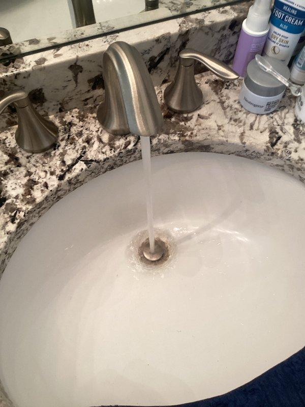 Completed comprehensive Green Shield membership plumbing inspection of residential property. Inspected bathroom fixtures including sink with three-piece brushed nickel faucet assembly, verified proper water flow and drainage operation, and examined bathtub with overflow drain system and stopper mechanism. Assessed 4-year-old tanked water heater located in basement as part of recurring preventative maintenance program.