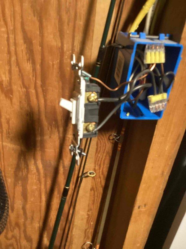 Responded to reported electrical hazard involving blistering wires for tankless water heater installation near light switch location. Upon inspection, found improper wiring methods with exposed conductors and inadequate connections at switch box on wooden wall framing. Corrected electrical rough-in by properly securing Romex cables to studs, installed code-compliant junction box, and made secure wire connections using appropriate connectors. Ensured all conductors were properly terminated and protected within electrical boxes to eliminate fire hazard and bring installation up to current electrical code standards.
