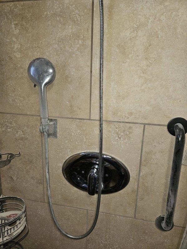 Installed two Moen single-handle Posi-Temp shower valves in upstairs and downstairs bathrooms. Completed installation included new shower arms, trim kits, handles, and showerheads for both locations, with wall access required for valve replacement and proper sealing upon completion.