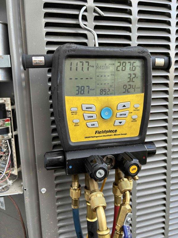 Responded to no cooling complaint on 5-6 year old heat pump system with outdoor condenser and basement furnace. Performed diagnostic evaluation using digital manifold gauges and clamp meter to assess system pressures, temperatures, and electrical performance on R410A unit. Accessed condenser wiring and components, measured operating parameters including suction/discharge temperatures and amp draw to identify root cause of cooling failure.