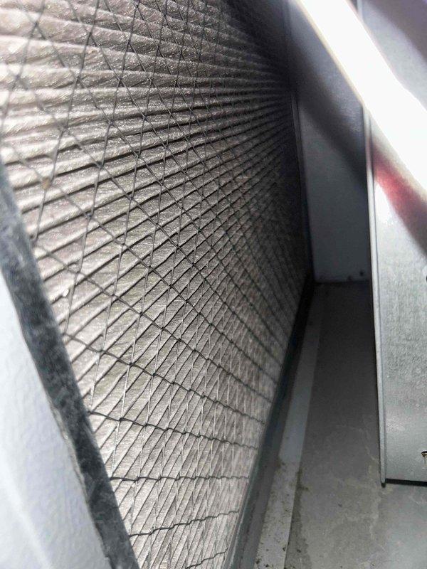 Completed routine maintenance tune-up on Goodman HVAC system with furnace located in basement and condensing unit on left side of home. Inspected air filter showing dust accumulation on diamond-pattern mesh, performed electrical diagnostics using clamp meter on furnace burner assembly and verified system operation. All equipment less than 7 years old and operating within normal parameters following preventative maintenance procedures.