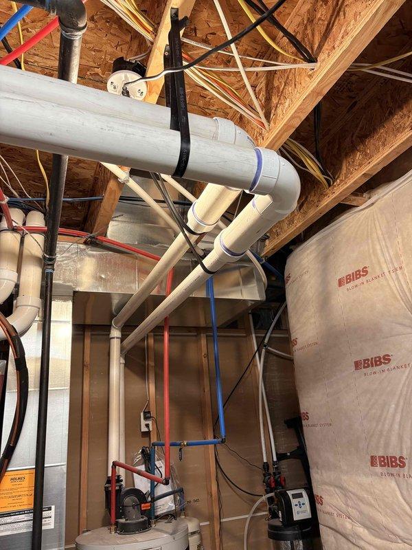Responded to no hot water condition with active water leak at 8-year-old tank-type water heater in basement utility area. Upon arrival, found customer had attempted self-repair which worsened the leak situation. Assessed failed pressure relief valve and compromised tank integrity causing continuous water puddling. Documented existing plumbing configuration including PVC supply lines and pressure gauge assembly. Recommended full water heater replacement due to age and extent of damage to tank system.