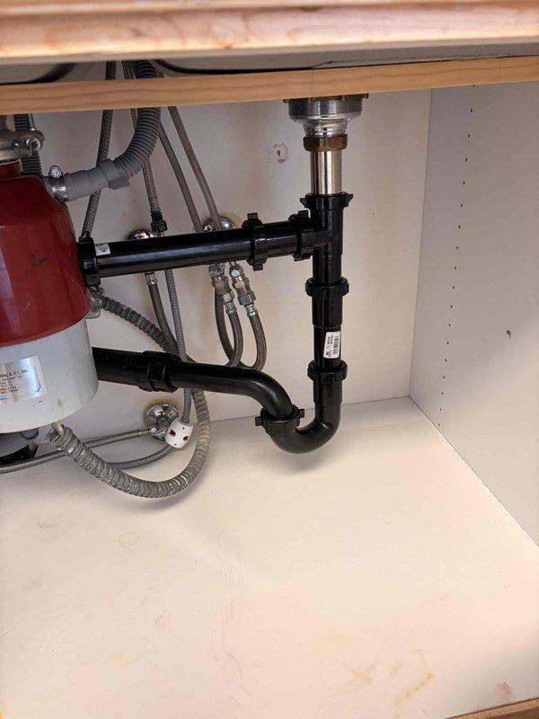 Responded to a severely clogged kitchen sink with slow drainage and recurring backup issues causing water to leak from the plumbing beneath the sink. Upon inspection, identified blockage in the P-trap drain assembly. Successfully cleared the obstruction, restored proper drainage flow, and verified all connections under the sink were secure with no leaks present. Tested the system by running water to confirm the issue was fully resolved and drainage was functioning normally.