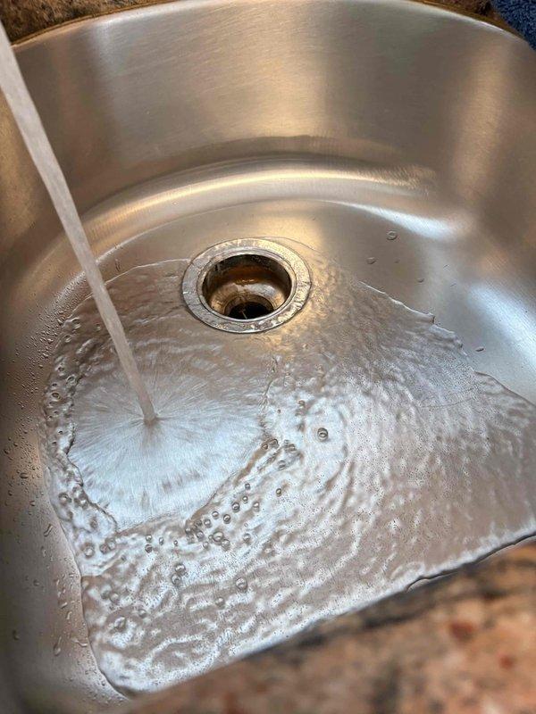 Responded to a severely clogged kitchen sink with slow drainage and recurring backup issues causing water to leak from the plumbing beneath the sink. Upon inspection, identified blockage in the P-trap drain assembly. Successfully cleared the obstruction, restored proper drainage flow, and verified all connections under the sink were secure with no leaks present. Tested the system by running water to confirm the issue was fully resolved and drainage was functioning normally.