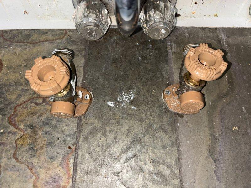 Completed annual plumbing maintenance inspection as part of Green Shield membership, including system pressure test, water purity test, and water heater flush in garage closet location. Inspected plumbing fixtures and shut-off valve assemblies, noting significant green patina and corrosion on bronze valve body with plastic fittings and flexible metal conduit connections. All scheduled maintenance tasks performed and system components documented photographically for record.