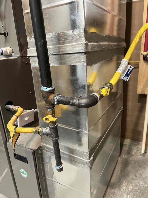 Installed Navien NPE-240A tankless water heater to replace existing unit. Ran 2" PVC venting system for exhaust and fresh air intake per code requirements. Extended 3/4" gas line with yellow CSST to unit location and installed shut-off valve. Installed 3/4" PEX hot and cold water lines with isolation ball valves for future service access. Mounted expansion tank and made all necessary electrical connections. Removed old water heater, tested new unit for proper operation, and verified all connections for leaks. Unit is operational with 5-year manufacturer warranty and 15-year heat exchanger warranty.
