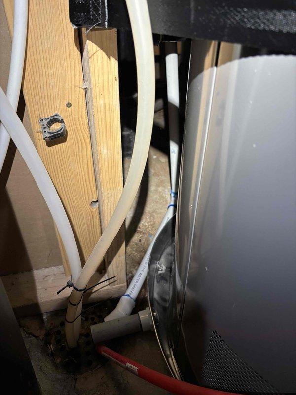 Responded to service call for AC condensate drain issue with water pooling around exterior PVC drainage line. Inspected HVAC air handler unit and associated condensate drainage system in mechanical closet, locating primary and secondary drain lines. Cleared obstruction from condensate drain line using appropriate drain cleaning methods, restoring proper drainage flow from the 4-5 year old AC system and eliminating water accumulation at exterior discharge point.