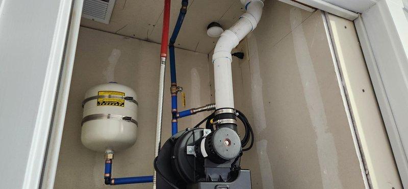 Completed installation of 50-gallon power vent water heater in utility closet with full code compliance. Removed existing water heater and installed new unit with PVC power vent system, expansion tank with blue and red PEX supply lines, new brass shut-off valve, flexible gas connector, and seismic restraint straps. Installed new water supply lines, tested all connections for leaks, fired unit, and verified proper operation of power vent system and gas valve. Unit includes 6-year manufacturer warranty and all installations meet current plumbing and mechanical code requirements.