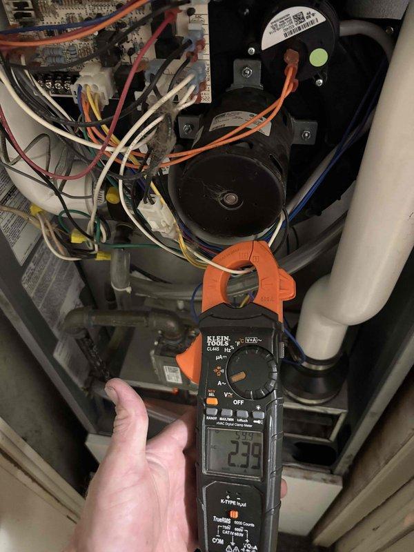Completed preventative maintenance on 4-year-old HVAC system located in mudroom area. Performed electrical diagnostics using clamp meter, recording amperage readings on system components and inspecting blower motor assembly, control board, and all electrical connections. Inspected interior ductwork for cleanliness and structural integrity, noting wire reinforcement and insulation condition throughout main trunk line.