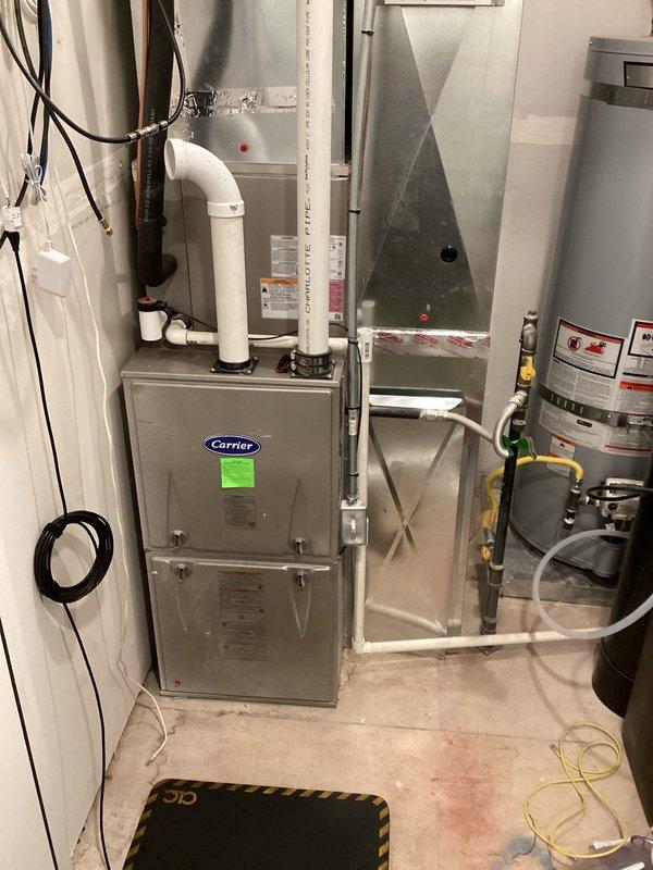 Responded to service call for frozen AC line. Upon inspection, found ice buildup on refrigerant lines connected to the air handler unit. Replaced dirty 20x25x1 air filter which was restricting airflow and causing coil to freeze. Verified proper airflow through system, checked refrigerant levels, and confirmed all components of Carrier furnace and A-coil assembly were operating within normal parameters. System returned to normal cooling operation with no further ice formation detected.