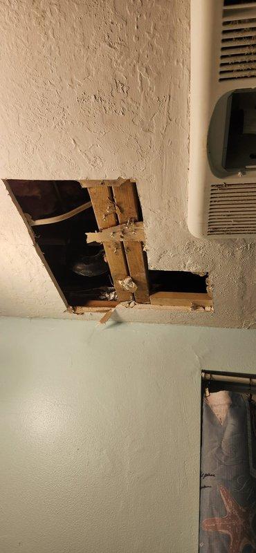 Installed new waste and overflow assembly using closed access method, tying into existing drainage system with no-hub band connections. Completed drywall repair and restoration work to access area, returning wall surfaces to finished condition.