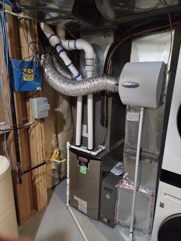 Completed dual furnace replacement installation at residential property. Basement system: installed EL297UH070XV36BK 90% efficiency furnace, upgraded PVC venting from 2" to 3" with two-pipe configuration, replaced existing 20x25x5 media cabinet with new 20x25 cabinet and MERV 11 filter, added bypass humidifier with 6" piping and necessary elbows, reused existing thermostat. Upstairs closet system: installed ML296UH045XV36BK 90% efficiency furnace with 2" two-pipe PVC venting, added new 16x25 filter rack with filter, reused existing thermostat. Both installations verified operational with proper venting, filtration, and humidification systems functioning as designed.