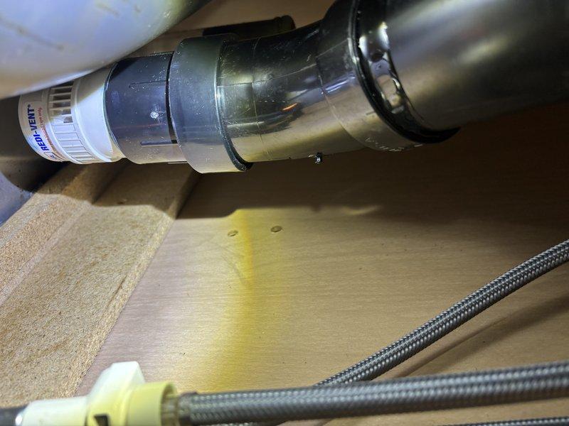 Responded to service call for slow-draining double-basin kitchen sink. Accessed plumbing assembly beneath sink and removed P-trap to clear blockage in drain line. Snaked kitchen drain through cleanout accessible under sink cabinet, successfully removing obstruction causing drainage issue. Reassembled P-trap and drainage components, tested both basins for proper flow, and confirmed all connections were secure with no leaks.